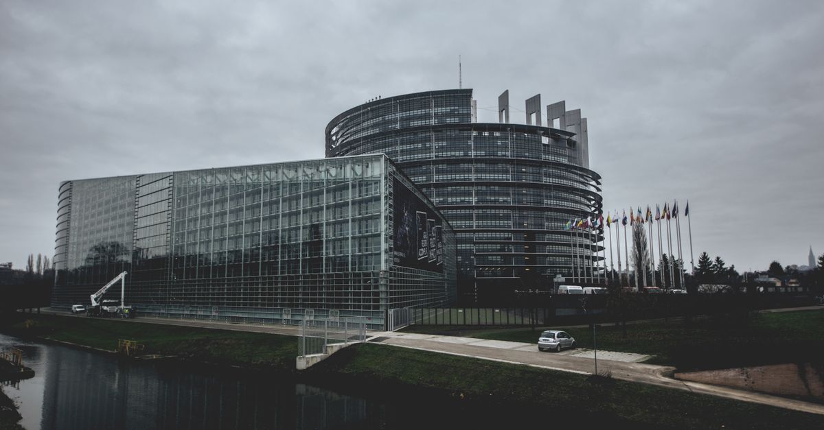 Modern architecture of the European Parliament in Strasbourg on a cloudy day.